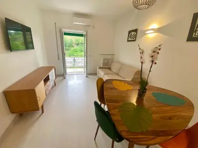 a living room with a table and a couch at Leone's rooms - House for 6 people in Rome
