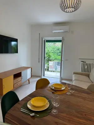 a dining room with a table with plates and wine glasses at Leone's rooms - House for 6 people in Rome