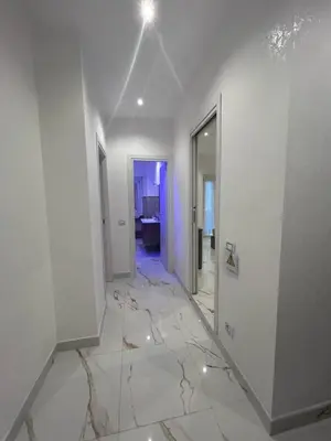 a white room with a cracked floor and a hallway at Vatican Splendid Dream Apartment in Rome