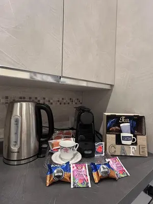 a kitchen counter top with a coffee maker and a tea kettle at Vatican Splendid Dream Apartment in Rome