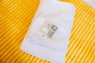a white napkin with a ring on top of a bed at Casa Medea in Rome