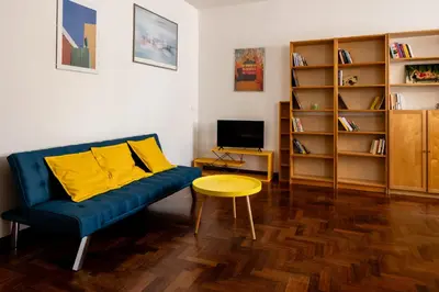 a living room with a blue couch and a table at Casa Medea in Rome