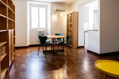 a kitchen and dining room with a table and chairs at Casa Medea in Rome