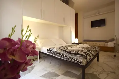 a bedroom with a bed in a room at Rouge studio - 10 min from Vatican in Rome