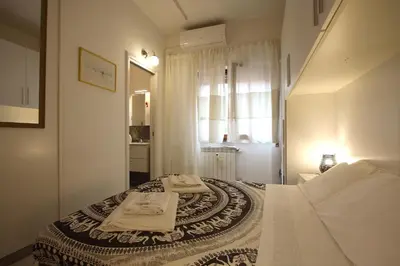 a bedroom with a bed with two towels on it at Rouge studio - 10 min from Vatican in Rome