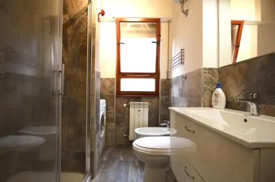 a bathroom with a toilet and a sink and a shower at Rouge studio - 10 min from Vatican in Rome