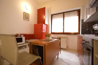 a small kitchen with a table and a microwave at Rouge studio - 10 min from Vatican in Rome
