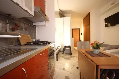 a kitchen with a sink and a stove top oven at Rouge studio - 10 min from Vatican in Rome
