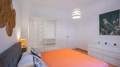 a bedroom with a bed and a dresser in it at EasyTopStay - San Pietro Apartment with Courtyard in Rome
