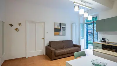 a living room with a couch and a table at EasyTopStay - San Pietro Apartment with Courtyard in Rome