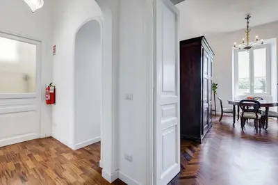 a hallway with a dining room and a table at Elegant 3-Bedroom Apartment in Piazza Mazzini in Rome