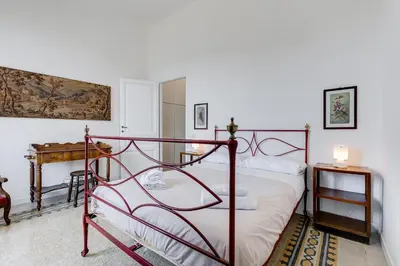 a bedroom with a metal bed in a room at Elegant 3-Bedroom Apartment in Piazza Mazzini in Rome