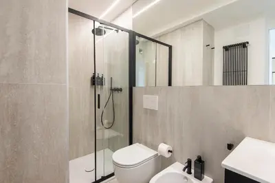 a bathroom with a shower and a toilet and a sink at Maison Ottaviano -Vatican- in Rome