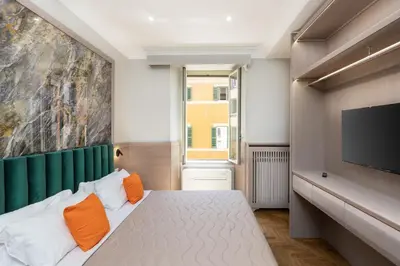 a bedroom with a bed and a flat screen tv at Iron Monti Coliseum in Rome