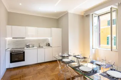 a kitchen with a dining room table with glasses on it at Iron Monti Coliseum in Rome