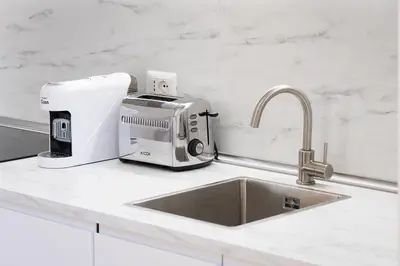 a kitchen counter with a mixer and a sink at Iron Monti Coliseum in Rome