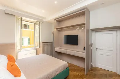 a bedroom with a bed and a flat screen tv at Iron Monti Coliseum in Rome