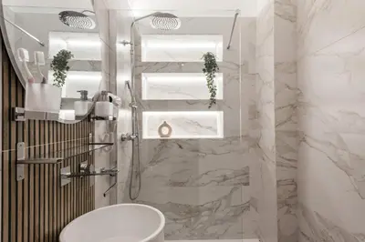 a bathroom with a shower with a toilet and a sink at The Best Rent - Refined multi-room apartment in Termini area in Rome