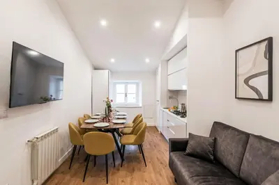 a living room with a couch and a table and chairs at The Best Rent - Refined multi-room apartment in Termini area in Rome
