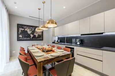 a dining room with a table and chairs at Trastevere Travertino Suite in Rome