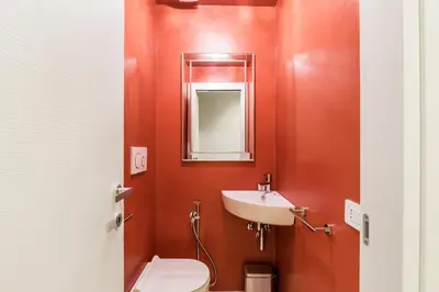 a bathroom with a white toilet and a sink at Trastevere Travertino Suite in Rome