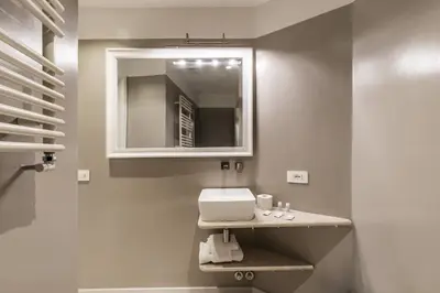 a bathroom with a sink and a mirror at Trastevere Travertino Suite in Rome