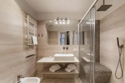 a bathroom with a sink and a shower at Trastevere Travertino Suite in Rome
