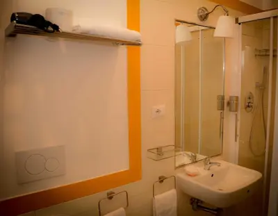 a bathroom with a sink and a shower with a mirror at Rome Together Guest House in Rome