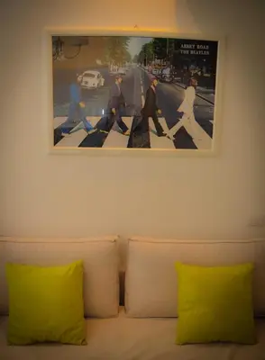 a picture above a couch with two yellow pillows at Rome Together Guest House in Rome