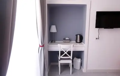 a white desk with a chair in a room at Rome Together Guest House in Rome