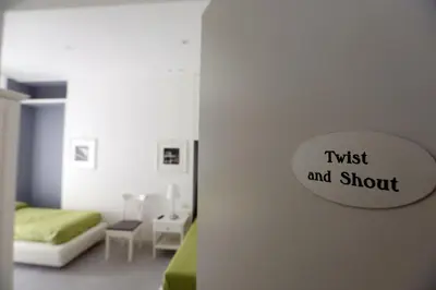 a bedroom with a bed and a sign that reads trust and shoot at Rome Together Guest House in Rome