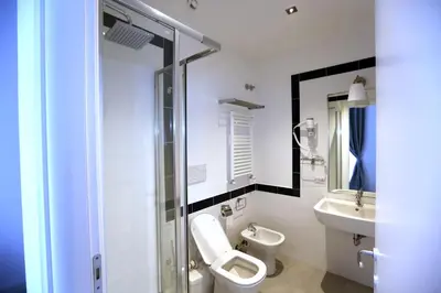 a bathroom with a toilet and a sink at Rome Together Guest House in Rome