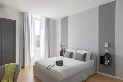 a white bedroom with a white bed and a window at iFlat La Dolce Vita - Contemporary Luxury in Rome in Rome