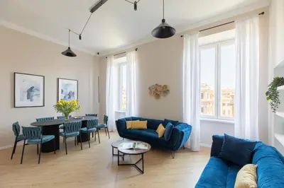 a living room with a blue couch and a table at iFlat La Dolce Vita - Contemporary Luxury in Rome in Rome