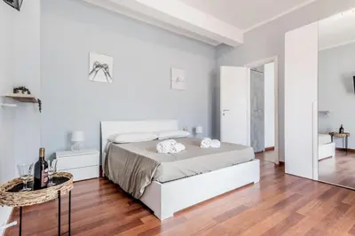 a white bedroom with a bed and a table at NEW OPENING Free Netflix BIG APT Pamphili House in Rome