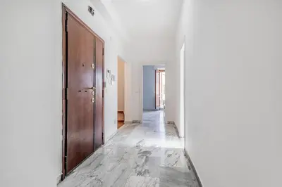 an empty hallway with a wooden door and a floor at NEW OPENING Free Netflix BIG APT Pamphili House in Rome