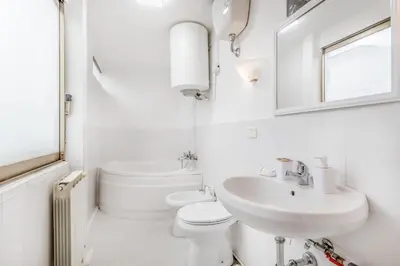 a white bathroom with a sink and a toilet at NEW OPENING Free Netflix BIG APT Pamphili House in Rome