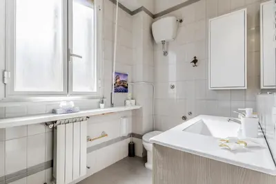 a white bathroom with a sink and a toilet at NEW OPENING Free Netflix BIG APT Pamphili House in Rome