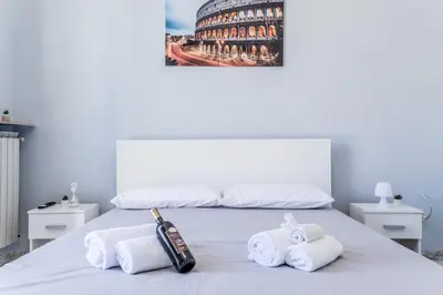 a bedroom with a bed with towels on it at NEW OPENING Free Netflix BIG APT Pamphili House in Rome