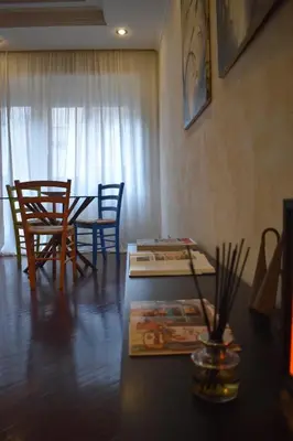 a living room with a table and chairs and a dining room at St Peter view House Vatican in Rome