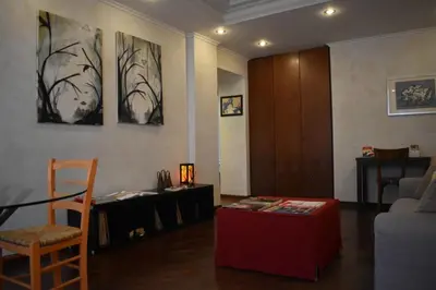 a living room with a table and a desk at St Peter view House Vatican in Rome