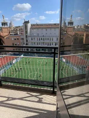 a view of a soccer field from a building at St Peter view House Vatican in Rome