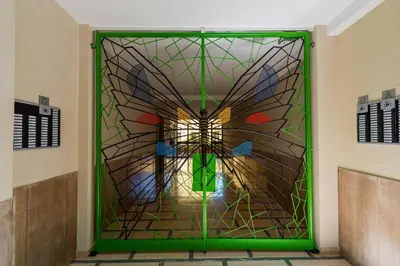 a green door with a stained glass image of an image of angth at AMORE MIO - Art House in Rome