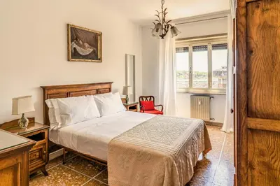 a bedroom with a bed and a red chair at AMORE MIO - Art House in Rome