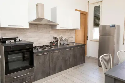 a kitchen with a stove and a refrigerator at Relais Rosselli in Rome
