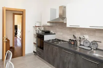 a kitchen with a sink and a stove at Relais Rosselli in Rome