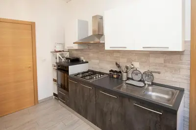 a kitchen with a sink and a stove at Relais Rosselli in Rome