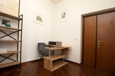 an office with a desk and a chair and a door at Relais Rosselli in Rome