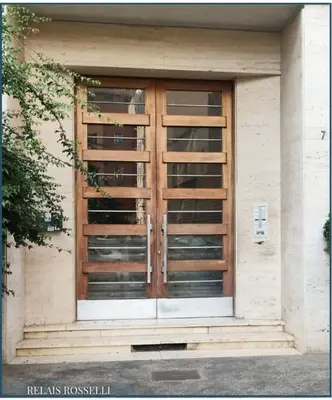 a front door of a building with wooden doors at Relais Rosselli in Rome