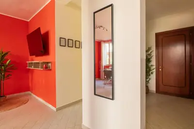 a hallway with red walls and a mirror at Urban Loft Piramide in Rome